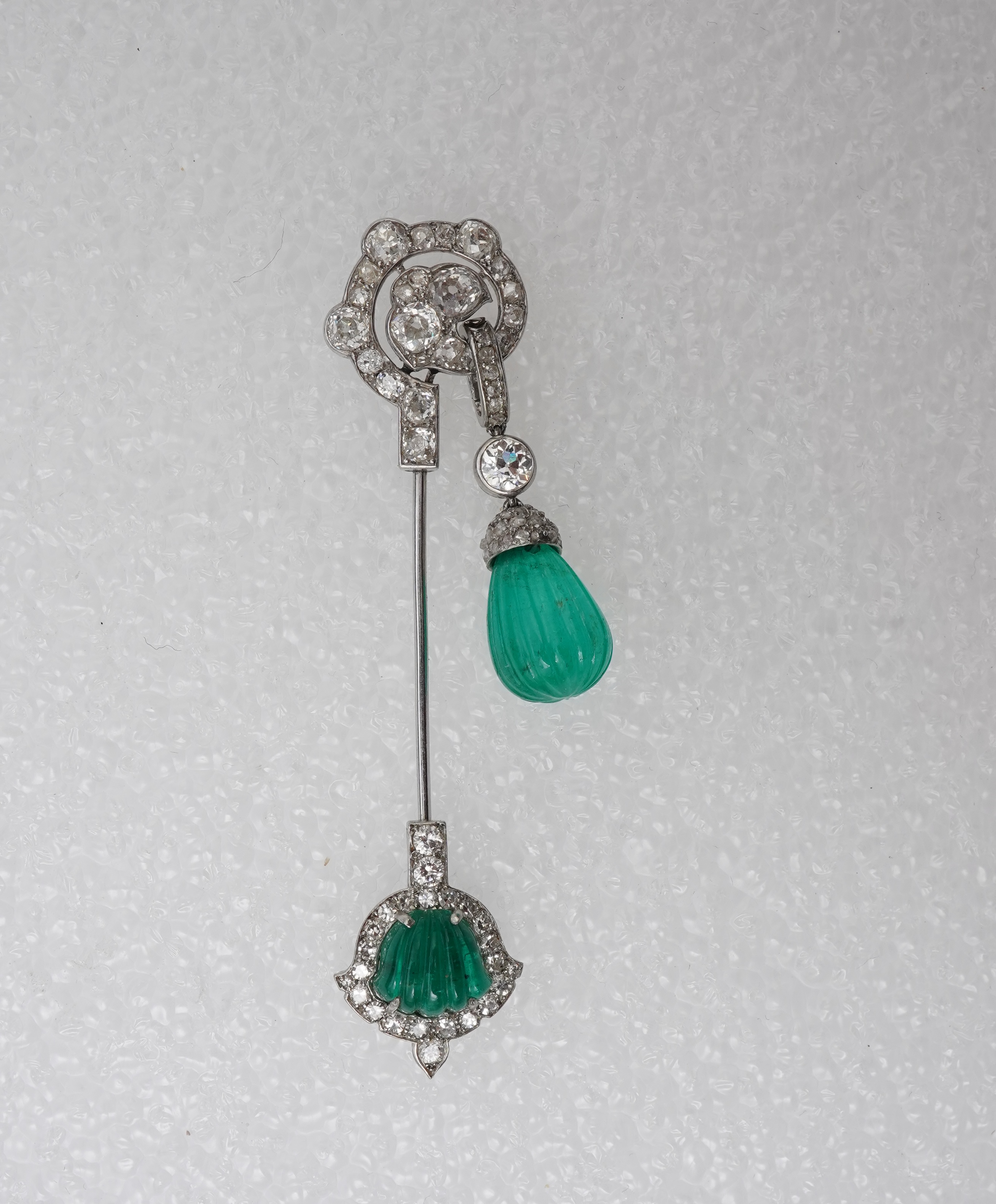 A fine Art Deco carved emerald and diamond jabot pin, circa 1925